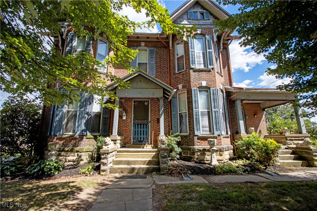Don’t miss your chance to own a piece of Sterling history! This beautiful 4-bedroom, 2-bathroom Victorian brick home, built in 1870, offers over 2,100 sq. ft. of living space and has been tastefully remodeled to maintain its original charm with stunning woodwork throughout. The home features a first-floor laundry, hardwood floors in the kitchen, a gas fireplace, two welcoming front porches, and a private rear patio perfect for relaxing or entertaining. The attic offers the potential to be finished for additional living space.
Adding to the appeal is a three-car detached garage and a spacious carriage house with its own garage, 2 bedrooms, 2 bathrooms, and a separate laundry area—ideal for a large family, in-law suite, or rental opportunity. This property is a true Victorian landmark in Sterling, Ohio, offering the perfect blend of historic character and modern convenience.
