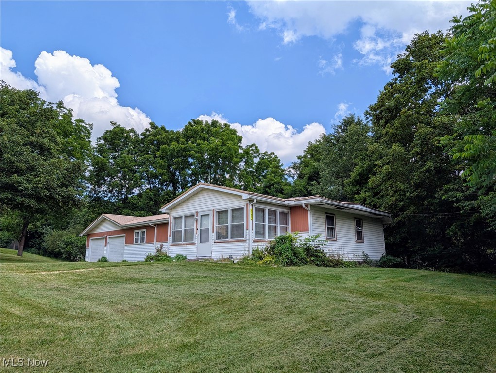 This little piece of heaven is waiting for you to make it your own. Enjoy country living, close to all the amenities in Calcutta, situated in Beaver Local School District, with easy access to Rte 11 and Rte 7. The stove, refrigerator, hot water tank and front windows are newer. An Amish metal roof was installed 1 year ago. There is another room with closet that can be an office or 4th bedroom. The basement is dry. The sump pump is for the ac and washer. There is also a gas well on the rear of property that can be tapped.