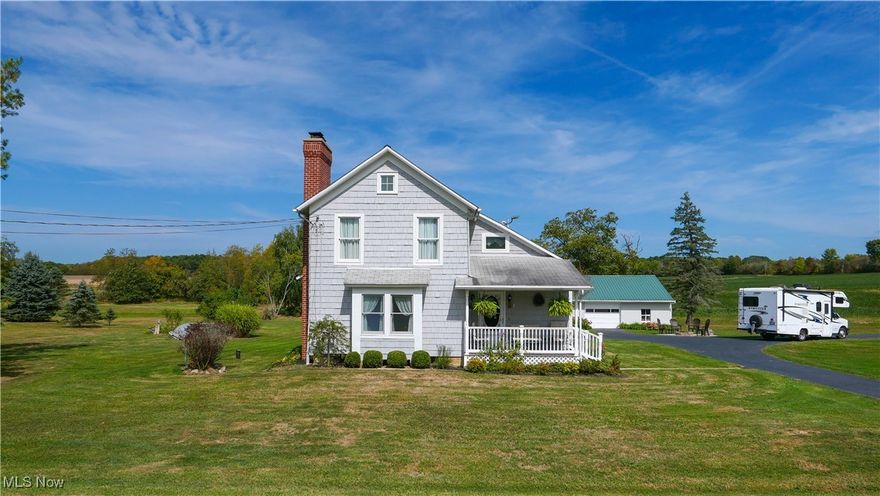 Nestled on a peaceful street surrounded by picturesque farmland, this charming cedar sided farmhouse offers a perfect blend of modern amenities and rustic beauty. The inviting front porch made of composite decking is ideal for relaxing, while the brick paver patio area and stone fire pit make outdoor entertaining a delight. Enjoy the 3 car outbuilding for all your outdoor toys! The large breezeway seamlessly connects the attached garage to the home, offering easy access. The updated kitchen features Corian countertops, a stylish metal backsplash, and a large island with seating, perfect for family gatherings. The living room boasts a cozy wood-burning fireplace flanked by built-in bookcases, along with a charming window nook for reading or enjoying the view. Additional highlights include first-floor laundry, a spacious downstairs bathroom, and a beautiful layout that combines comfort and functionality. The wide staircase leads to three spacious bedrooms, including a master with stunning views of the yard, and a full bath with a convenient laundry chute. This serene home offers a perfect retreat with modern upgrades, surrounded by nature's beauty.