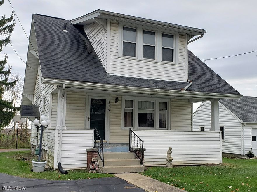 Welcome Home! So much potential in this 1925 Craftsman style home. One step on the front porch and you'll be imagining yourself on a porch swing enjoying your favorite beverage. Greet your guest in the large living room which features a 1/2 bath, 3 original Craftsman style windows to front porch and an arch open entry to the dining room. So much nostalgia in the dining room with built-in bay window bench seat, corner wall china cabinet and 2 small windows known to the Craftsman style. Kitchen just off the dining room will surely bring back the memories. Kitchen comes with stove and dishwasher. Family built a microwave cabinet in the window to the porch but could easily be removed. Window is still there. Original laundry was in the full basement but washer & dryer have been moved to back porch. 3 bedrooms and a full bath on the second level. 2 car detached garage. Black top drive has plenty of room for family and friends. Many of the windows are newer. Back porch with French doors is a