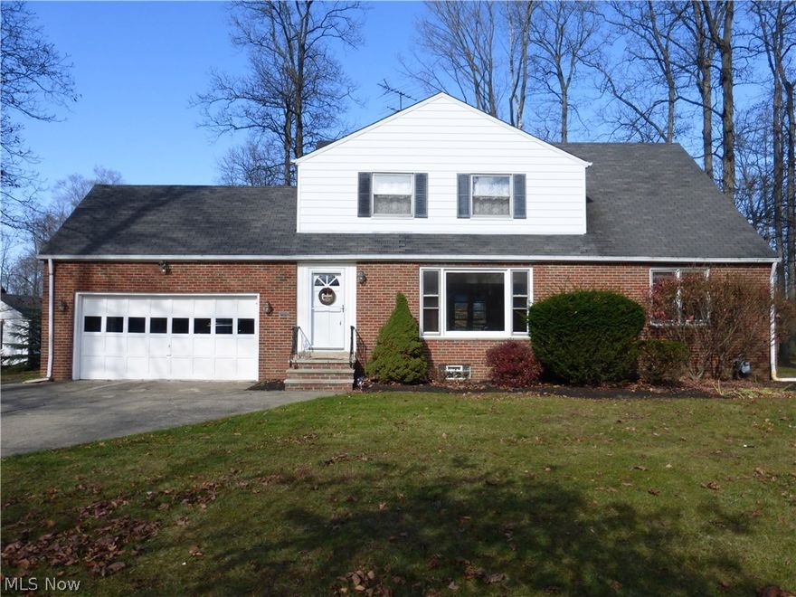 Just move in and enjoy the best of both worlds, a country like setting close to the conveniences of the city.  All yard maintenance, landscape bed maintenance, fall yard clean up, and snow plowing are included. This fantastic home has 4 bedrooms with a possible 5th bedroom and 2.5 bathrooms, with newly refinished wood floors, freshly updated kitchen with a new gas range, wonderful subway tile back splash, new counter tops, new sink and faucet, new lighting, new flooring, a partially finished basement, separate living space on the second floor with its own kitchenette and living room or possible 5th bedroom, an attached two car garage, a wonderful park-like backyard, and a beautiful deck to enjoy it from. The home features nice large rooms with 3 bedrooms on the main level and 2 bedrooms, one of which was used as a living room, newer furnace, new vanity in the main floor bathroom. The spacious basement is partially finished with carpeted floor on one side and plenty of storage. The deep