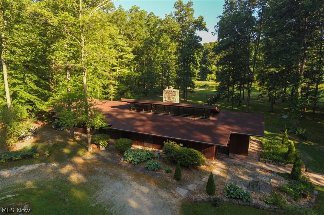 Custom built, waterfront home is ready for your lifetime of fun and enjoyment. Welcome home to 36 picturesque acres of paradise including a fantastic, fully stocked pond with floating dock! Architect Gerald Rembowski, known for Frank Lloyd Wright style homes, designed this beautiful Redwood sided, 4 bedroom, 2 1/2 bathroom ranch, contemporary home with soaring ceilings, gorgeous stone fireplace, and abundant views of the lake and woods from every direction! Enjoy scenic trails thru the woods containing numerous mature Oak, Hickory, Maple & Beech trees! Detached 2+ car garage with heated office or extra storage area! Fenced in area behind is perfect for pets or children! Large 13x26 deck and quaint patio too! Huge temperature controlled outbuilding with bathroom is perfect for your home based business or for the savvy collector! Super cute heated & cooled granary building too with root cellar and wood burning stove could make the perfect area for classes, crafts and endless possibiliti