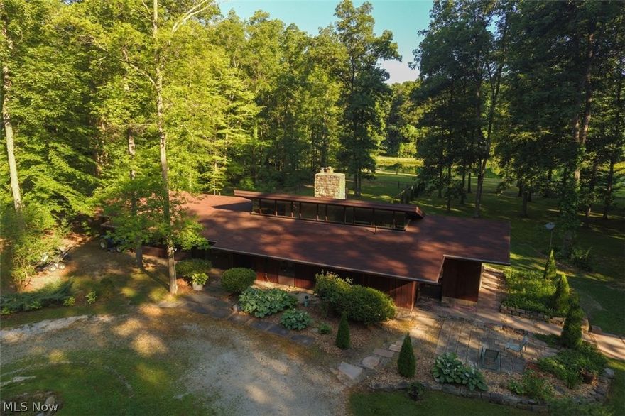 Custom built, waterfront home is ready for your lifetime of fun and enjoyment. Welcome home to 36 picturesque acres of paradise including a fantastic, fully stocked pond with floating dock! Architect Gerald Rembowski, known for Frank Lloyd Wright style homes, designed this beautiful Redwood sided, 4 bedroom, 2 1/2 bathroom ranch, contemporary home with soaring ceilings, gorgeous stone fireplace, and abundant views of the lake and woods from every direction!  Enjoy scenic trails thru the woods containing numerous mature Oak, Hickory, Maple & Beech trees! Detached 2+ car garage with heated office or extra storage area! Fenced in area behind is perfect for pets or children! Large 13x26 deck and quaint patio too! Huge temperature controlled outbuilding with bathroom is perfect for your home based business or for the savvy collector! Super cute heated & cooled granary building too with root cellar and wood burning stove could make the perfect area for classes, crafts and endless possibiliti