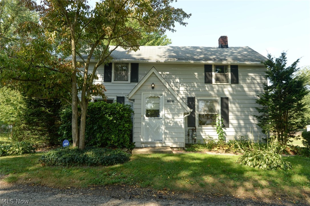 A Lake Township steal! This home has 3 bedrooms, 2.5 bathrooms, a finished basement with bonus room, rec room and a kitchen all on 2 lots! Main floor kitchen includes range, refrigerator, dishwasher, charming spice pantry and unique cabinets. There is a large bedroom, full bath and big linen closet on the first floor. Full dining room with an adorable light fixture and large living room with built in book shelves, front entry way and coat closet. Original hardwood floors under first floor carpets. Head upstairs to the remaining adjoining bedrooms and half bathroom. Downstairs there's more space for family time, a great man cave or an apartment space. There are 2 finished rooms, a full bathroom, kitchen with laundry area, a storage room and tons of hidden closets and shelving. Out back is the brick patio that leads to the awesome enclosed patio room. This room is built out of beautiful old beams, has a ceiling fan and a wet bar. The landscaping creates lots of charming nooks