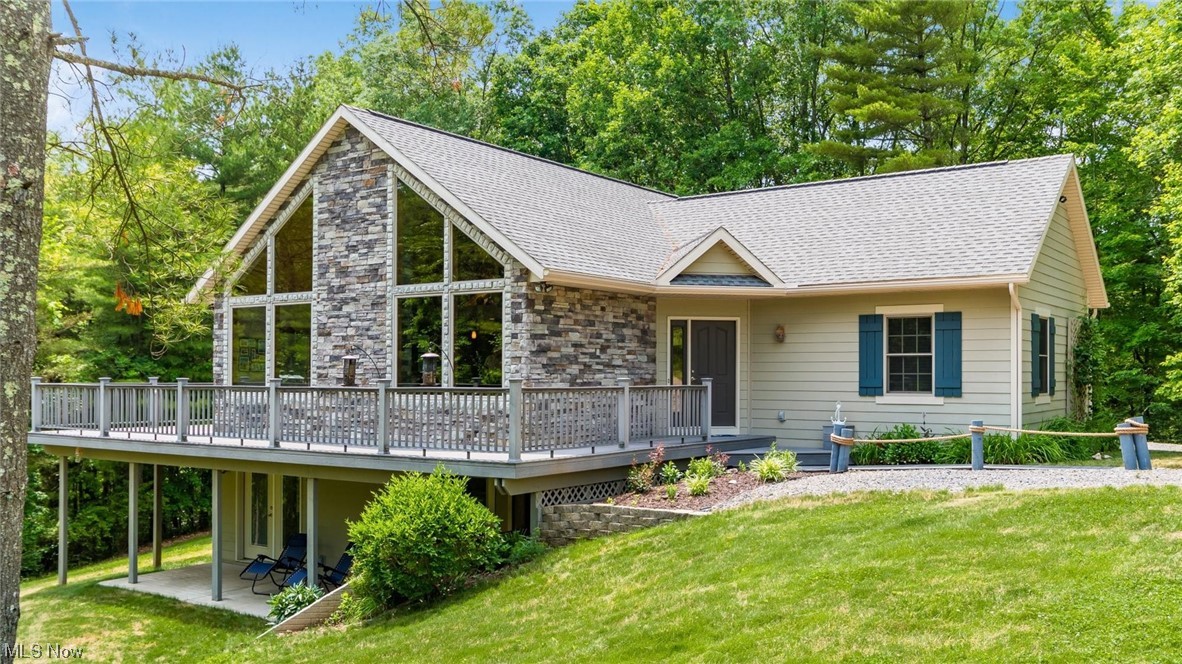 Introducing a remarkable custom-built home located only a half mile from the breathtaking Seneca Lake. This one-owner property boasts an impressive 3100 square feet of luxurious living space, situated on a serene private lane enveloped by 2.5 acres of natural beauty. Crafted with meticulous attention to detail, this home exudes quality construction and offers many unique features. Inside discover an inviting open floorplan that blends elegance and functionality. The vaulted cedar ceiling soars above, creating an airy and spacious atmosphere throughout the main living areas. The ambiance is enhanced by two cozy fireplaces that add warmth and charm to the living spaces, which provide the perfect settings for relaxation. The expansive finished lower level is a true gem, with a wet bar, which provides an excellent space to host gatherings. Four spacious bedrooms, a loft and three baths ensure ample accommodations for family and guests. Each room has been thoughtfully designed to offer comf