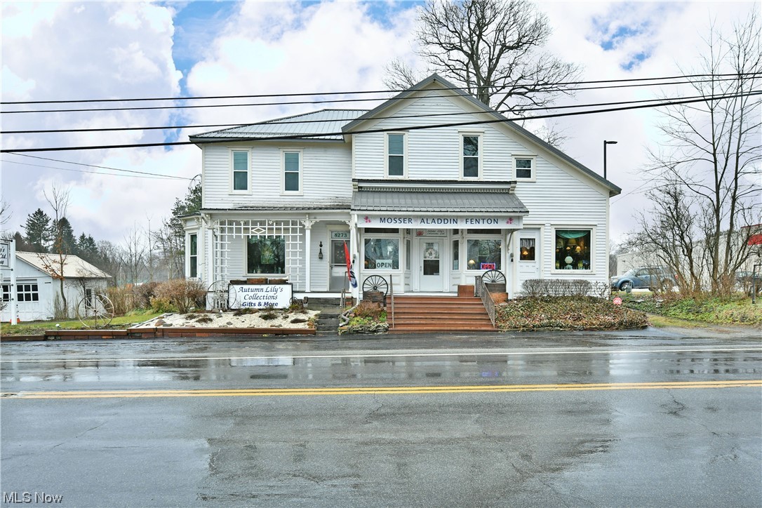 A unique opportunity like no other, this converted turn of the century home combines an impressive amount living space paired with a current storefront style offering; all in the heart of Kinsman! The substantial residence includes a sprawling lot to include both a single car detached garage and a rustic carriage house out back, easily converted to additional frontage, entertainment or equipment storage. A modern, gray metal roof slopes down from above the home, complimenting the pair awnings that grace both the main staircase and flowerbeds. Inside, an expansive front showroom brings plenty of shelving while a main counter offsets a rearward workshop with sink, half bath, basement and security system access. Colorful side rooms branch away with large windows that fill the floorspace with natural light. Opposite, a living room styled area is found just past a kitchen, laundry and rear mud room. Upstairs, three freshly remodeled bedrooms bring the potential total to five. Each of the rooms showcase bright colors, thick white trim work and lush carpets. They are joined by a second full bath set just off the main landing. Call today for more information!