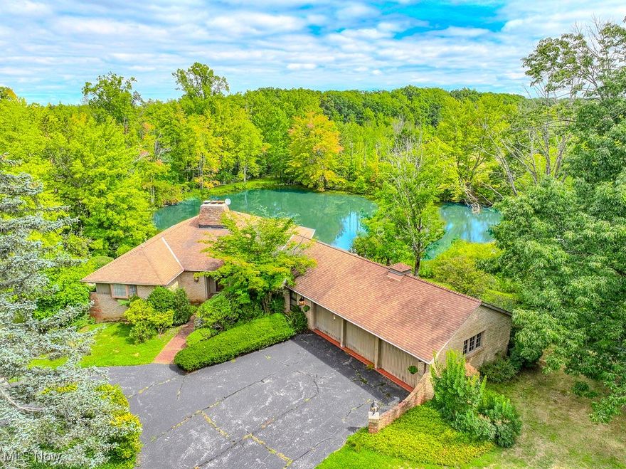 Welcome to this one-of-a-kind property, offering just over 12 breathtaking acres stretching from Viewmount to Hermitage with the potential to be split into three parcels. With two stocked ponds, a stream, a waterfall, wooded acreage, and an open valley, the setting is as picturesque as it is versatile—truly endless potential.

The 3,890 sq. ft. ranch-style home features 4 bedrooms, 3 full baths, and a desirable layout for both everyday living and entertaining. The main floor offers 2 bedrooms and 2 baths, including a spacious great room with soaring beamed ceilings, a Juliet balcony overlooking the pond, and a stunning stone wood-burning fireplace. The walk-out lower level provides 2 additional bedrooms, 1 full bath, and a large rec room with another stone fireplace, wet bar, and coffered ceiling—perfect for gatherings. Step outside to a serene patio where you can unwind by one of the beautiful ponds.

Additional highlights include a 3-car attached garage with terracotta flooring, a 2½-car detached garage with a second driveway, and an older barn on the property, adding charm and functionality.

This exceptional property blends natural beauty with generous living space—an opportunity not to be missed.