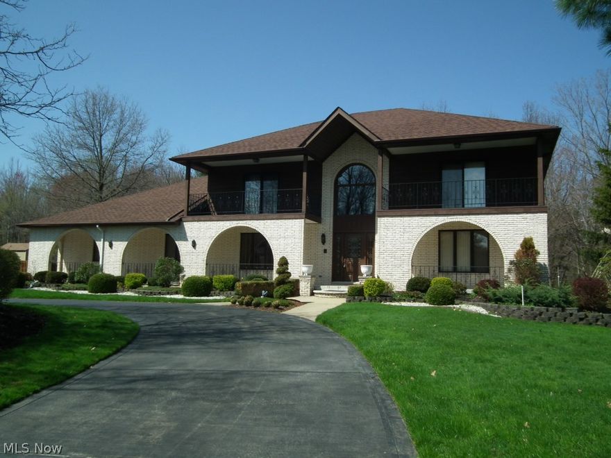 A two story marble foyer welcomes you to this magnificent custom built brick home. Today's living. Updated kitchen with center island, granite counters, wood floor and large dining area with fireplace and  is attached to the vaulted great room with a see-through  fireplace and access to a beautiful stone patio. Formal dining room offers a great opportunity for entertaining! First floor bedroom with full bath and walk-in closet. Master suite on first or second floor with glamour bath, walk-in closet and large sitting room. Three additional bedrooms on second floor and another  full bath. The bedrooms all have access to the balconies. The lower level has a full bath, spacious recreation/media room and lots of storage! Do not miss this home in prestigious Hanover Woods!