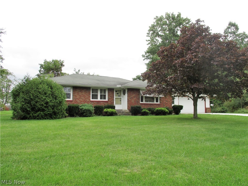 3-bedroom brick ranch waiting for a new owner. Main floor updated bath with ceramic tile shower and walls. Large living room w/ coved ceilings. Main floor laundry room/breezeway. 2-car attached garage w/ work bench and insulated overhead door. Brand new extra wide concrete driveway in 2018. Roof approx. 10 years old - by Senita. Vinyl windows. New boiler in 2007. Hot water heater 2009. Lower level has a shower, toilet and large wash tub - ready to be enclosed and remodeled into a 2nd full bath. All appliances can stay with the home - gas range and extra wall oven, counter top microwave, refrigerator, movable dishwasher, washer, dryer, freezer and 2-window a/c units. Located on 5-lots, all the way to E. 24th St. Property is being sold in as-is condition. Less than 2 miles to Lake Erie amenities. Bring offers.