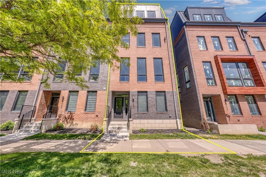 MOVE IN READY Beautiful Avenue townhome End Unit. Want to be within footsteps of Downtown Cleveland's Public Square, Playhouse Square, sports stadiums, downtown grocery store, the Lake Erie fronting Voinovich Park and so much more?? Pick this townhome with beautiful brick facade, incredible windows and rooftop deck as your home base and save THOUSANDS per year with a full city of Cleveland tax abatement through 2037!! Enter through a 2-car heated garage or gracious front entry and behold beautiful luxury vinyl flooring throughout the 2 primary living levels. A private bedroom suite on first floor with attached full bathroom is also fantastic home office option. On floor 2, expansive 10-foot ceilings create an open, airy atmosphere that enhances the home's sense of space. A showstopping kitchen is a chef's dream, featuring a large stone island, full suite of high-end appliances, walk in pantry plus 42-inch soft-close cabinetry for both style and function. Owners have installed custom blinds throughout the home! Kitchen opens to dining area and a living space that can fit large sectionals and is centered by a chic electric fireplace. The master suite offers a spa-like retreat with double sinks and a stunning tiled shower with a frameless glass door. Large, modern black windows further amplify the home’s bright, open layout. Bedroom 3 also has it's own bathroom AND walk in closet that is currently doubling as yet another home office option! A laundry area with washer dryer included rounds out this bedroom level. Guests will be MOST impressed by the roof level's entertainer’s paradise. A generous recreation room with second half bath AND wet bar where one can walk out to a private outdoor roof deck and view the LAKE and CITY?! An urban oasis indeed. 265 square feet of rooftop deck for outdoor enjoyment. Elevate your lifestyle with a home that offers style, functionality and all located in our amazing downtown Cleveland.