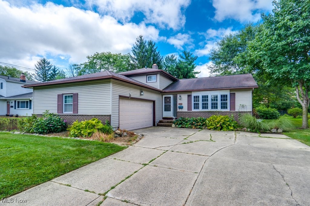This one-owner split-level home is the perfect opportunity for a new buyer to put on the finishing touches and enjoy instant equity. Featuring hardwood floors in the spacious living room and all three upstairs bedrooms, this home offers timeless character with modern updates already started.
The large, eat-in kitchen has been beautifully renovated—complete with abundant cabinet and counter space, a brand-new down-venting gas stove, and an open view to the lower-level family room. The family room, with its charming wood-burning fireplace and built-in bookshelves, is ready for its new flooring (already on site and included). A versatile bonus room on the lower level could be your home office, craft space, game room, or even a 4th bedroom. You’ll also find a laundry area and a full bath with a walk-in shower for added convenience.
The oversized garage includes storage shelving, a Nature Stone floor, and a water hookup—perfect for projects or hobbies. Upstairs, you’ll find three comfortable bedrooms and a large full bath. Step outside to a tremendous backyard—ideal for entertaining, relaxing, and enjoying privacy year-round.
Contractor estimates suggest $20–30K to fully complete the renovations, giving the next owner built-in equity. Don’t miss your chance to make this home your own in a great Twinsburg location—priced to sell! Agent related to seller.