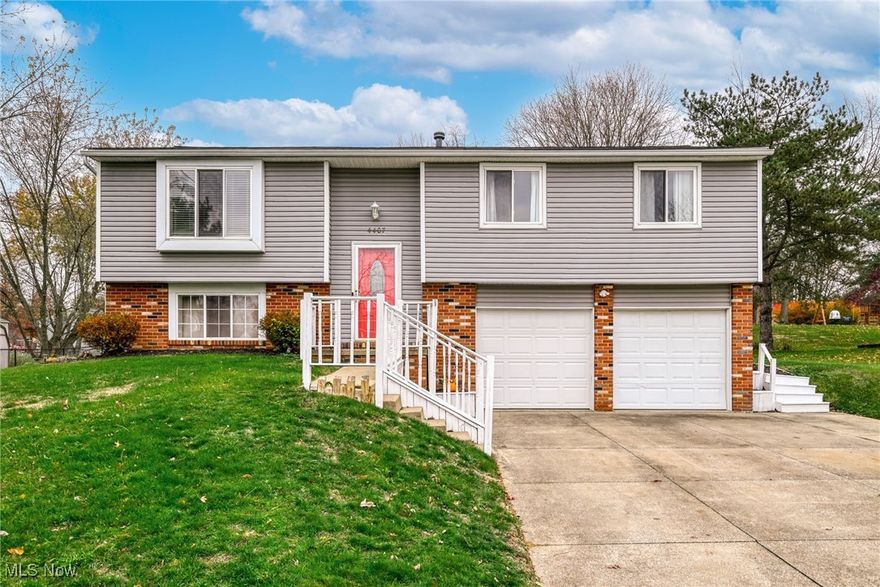 Welcome home to this lovely Bi-Level located in the highly desirable Green Local School District! This delightful 3-bedroom, 2.5-bath residence offers an inviting layout that balances comfort and functionality. Step into the welcoming foyer and up to the spacious main level, where natural light fills the open living and dining areas—perfect for gatherings or quiet nights in. Just off the dining room, a deck overlooks the large backyard, the perfect spot for morning coffee or summer barbecues. You can even pick apples from your own tree! The bright kitchen feels fresh and inviting with white cabinetry and lovely wood floors. Down the hall, you’ll find the main bath featuring a brand-new bathtub (2025), a serene primary suite with a private bath, and two additional nicely sized bedrooms. The lower level offers a versatile additional living space—ideal for a recreation room, home office, or guest suite—and includes a convenient half bath. Perfectly situated near the Green YMCA, Veterans’ Memorial Park, Central Park, restaurants, shops, and the Akron-Canton Airport, this home combines comfort, charm, and convenience. Don’t miss your chance to make it your forever home!