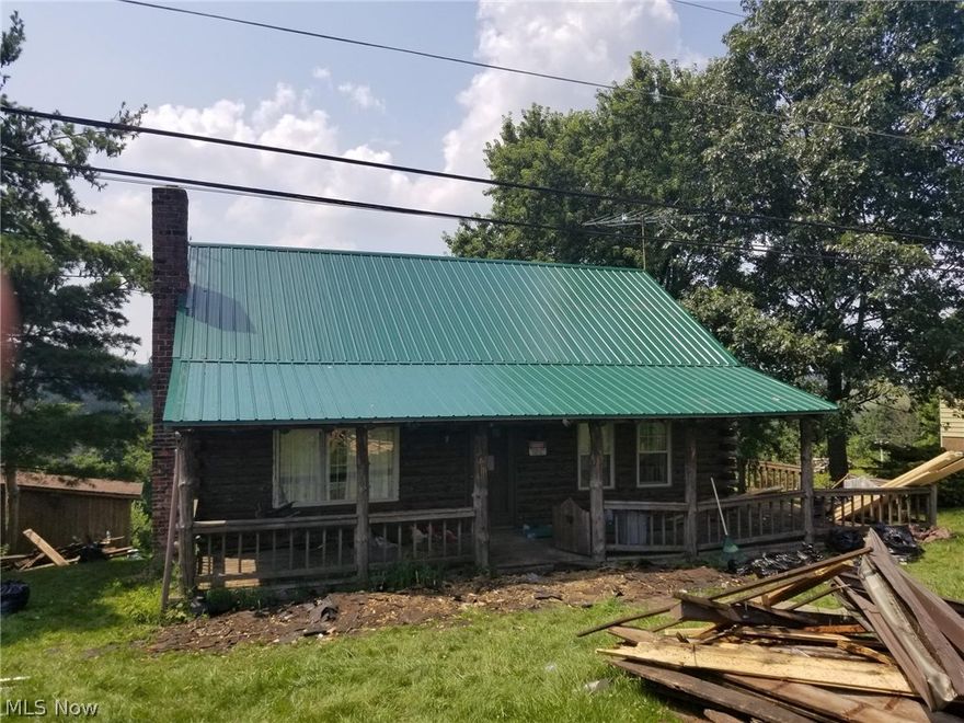 Log home with 3 bedrooms, 1 full bath & 3/4 bath in basement.  Sold "AS IS".
