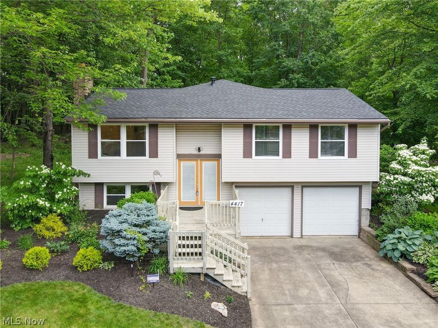 Sitting on an incredible lot, this 2068 SF bi-level home is ideal for those looking for a backyard retreat. The first floor is opening with a Tastefully updated kitchen with gorgeous black granite counters, compliments the white cabinets with stainless appliances including a gas range. This kitchen has ample counter space for cooking and entertaining. The living room / sitting area has vaulted ceilings. The primary bedroom windows overlook the lush backyard and lends to an updated full bath with a tiled shower with glass doors. Three additional bedrooms on the main floor. The second bathroom features a nice soaking tub + shower with surrounding tile. Designed with ease in mind is the laundry room on the main floor. The lower level features a rec room with brick surround fireplace and a large walk-in closet. A half bath is on the lower level and leads to the two car garage. The expansive deck is perfect for enjoying those long summer evenings. Many updates! Ask for improvements list. Home warranty included. New roof 2022, Interior painted in 2021. New carpet and flooring on main floor 2021. Kitchen Appliances updated within the last 3-4 years.