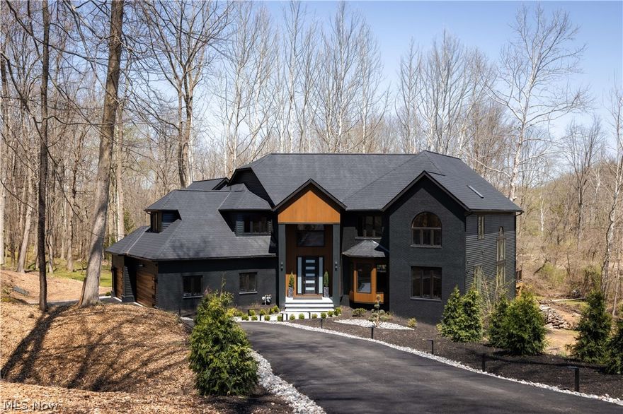 Rare opportunity to own a fully renovated luxury modern home in one of Solon’s most desirable areas, the prestigious Chagrin Highlands community, located within the top-rated Solon School District. This exceptional residence features 6 bedrooms and 5 full bathrooms with high-end finishes and custom design throughout. Den/Office on the first floor could also be the 7th bedroom.  The main level showcases a stunning open-concept layout with soaring 20+ ft ceilings, a dramatic floor-to-ceiling gas fireplace, and oversized picture windows filling the home with natural light. The designer kitchen is a true centerpiece, featuring custom cabinetry, a massive 22-ft quartz waterfall island, high-end appliances including a 48” ZLINE range, smart refrigerator, double farmhouse sinks, beverage fridge, and built-in pop-up outlets with charging stations. The home offers a versatile layout with four bedrooms on the second floor, a main-level Den/Office w/closet is ideal for guest suite (7th bedroom), and two additional full bedrooms with closets and large windows in the fully finished walkout basement. The basement provides exceptional living space with windows on three sides, two sliding walkout doors, a full bathroom, stylish wet bar with refrigerator, dishwasher, and sink, plus an electric fireplace. The luxurious primary suite features a private balcony, custom closets, and a spa-inspired bathroom with steam shower, freestanding tub, heated floors, and smart features. Outdoor living is equally impressive with a newly built ~1,500 sq ft composite deck, brand-new stamped concrete patio, professional landscaping, and custom exterior lighting throughout—perfect for entertaining. Seller will install a brand-new roof and replace the majority of siding prior to closing, offering added value and peace of mind. Additional highlights include two laundry areas, designer lighting, and extensive upgrades throughout, making this a true move-in-ready luxury home. See Agent remarks
