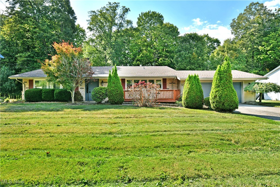 Four Bedrooms and three full baths await in this move in ready Canfield home! Welcome to 4232 Adeer Drive! Nestled on half an acre, this rear split level offers plenty of room to roam. The large living room greets you as you enter with a lovely wood burning fireplace and pops of original mid century flair coupled with low maintenance wood look flooring all bathed in natural light. Flowing seamlessly, the oversized eat-in kitchen is steps away and offers granite countertops, tons of cabinetry, pantry storage, and a breakfast bar to make entertaining and daily life a breeze. The kitchen also offers access to the attached 2 car garage. Head upstairs to find 2 nicely sized bedrooms and a full bath in addition to a main en suite with access to the rear balcony. The lower level is home to a large family room area with newer carpet and a second wood burning fireplace! The fourth bedroom is set opposite this space and would make a great home office or workout area as well! Another full bath and cozy laundry room round out the space. Head out the sliding door to your incredible backyard for an evening spent around the firepit or relaxing on the private deck! What are you waiting for? Call today for your personal tour! **Updates - All New Windows 2023, Fresh Paint 2025, HVAC 2020, New Driveway 2020, Roof 2017, Siding/Gutters/Gutter Guards 2017