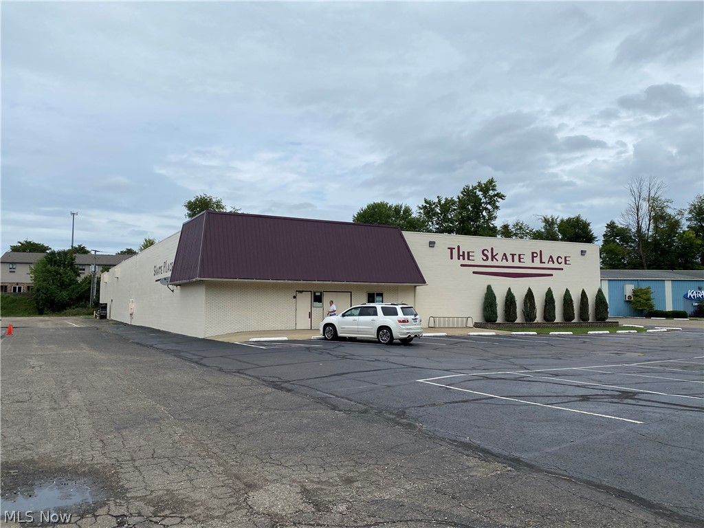This is your opportunity to own one of New Philadelphia's most cherished businesses, The Skate Place! Spacious commercial building with 20,000+/- square feet; skating rink is 70' x 140" (+/-). Includes all equipment-Arcade games, tables and chairs, skates and all additional items. This business is turn key. Property being offered with or without the business. Many possibilities! On site parking with 38+/- parking spaces on a 1+/- acre lot. Great location, just minutes from State Route 250 and Interstate 77. Located in a high traffic area, adjacent to Rural King.