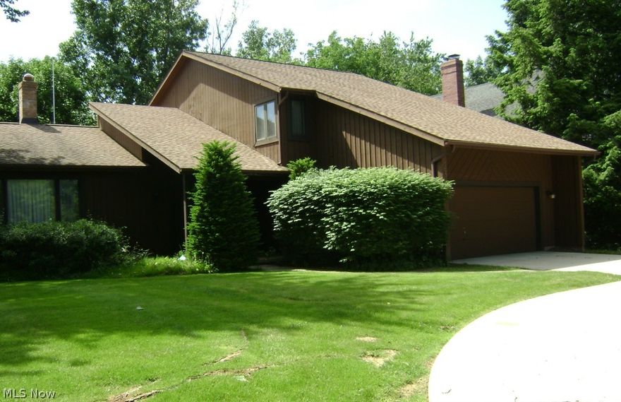 Custom built split w/circular driveway is on a beautiful lot. The home has an Open Floor Plan & Cathedral Ceilings in most rooms, & with the many windows there is a bright and airy feel to the home. 4 BR w/3 full baths & neutral decor. A large entry accesses the 4th bedroom & Full bath, a laundry & all other areas of the house. It has a large  kitchen with an eating area & island w/ storage. It includes wall microwave and oven, indirect lighting, and desk. Some cabinets have pull-out-shelves.The Family Room is off the Kitchen and has a WBFP w/gas starter, a wet bar w/ shelves & is wired for surround sound. The 4th BR and full bath are just 2 steps down from the main part of the  house. Master Bath includes double sinks, newer shower w/ Swiss temp control, skylight, tub, and dual flush toilets. The other 2 BR have walk in closets. The upstairs hall includes a Juliet Balcony w /high ceiling. More features include a newer generator, a tank-less water heater (2008), newer Rheem furnace & t