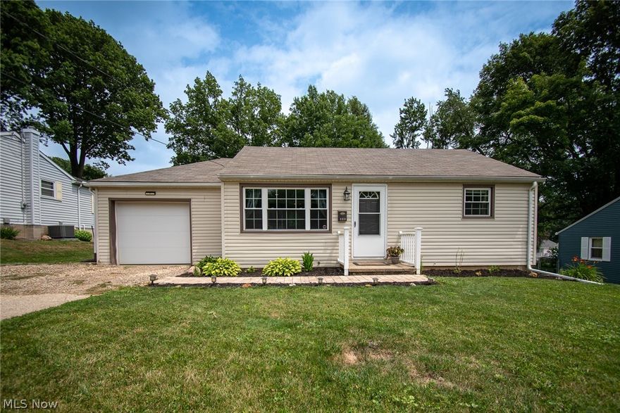 Welcome to this updated, well maintained 2 bedroom ranch with 1 car attached garage and spacious deck overlooking the backyard green space which includes 2 parcels.  The lovely landscaping welcomes you through the front door that opens to the living room with large picture window and new wood laminate flooring extending to the kitchen.  The kitchen hosts ample cabinet and counter space, vaulted ceiling and all appliances stay.  Two nice size bedrooms and a full bath remodeled with ceramic tiling flooring, new vanity and barn door linen closet complete the main level.  You'll find fresh paint and updated light fixtures throughout.  Garage access is through the kitchen.  From the garage you can access the basement which offers tons of storage space, the utility area and laundry.  Also from the garage is patio access where you can enjoy grilling and entertaining.  Roof, windows, furnace, AC and hot water tank are all approximately 8 years old.  Come check this one out for yourself. Schedu