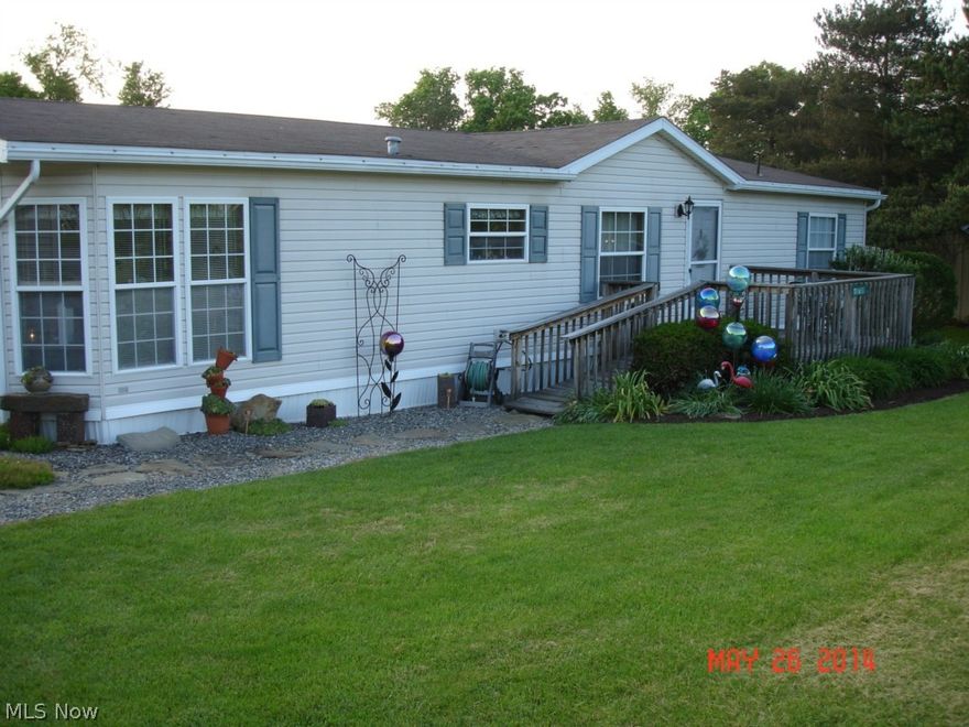 This home sits in  a park like area near Lore City.  It is a manufactured home that was only lived in for 2 years and has been used as a vacation home since 1997.  It is "Beautiful"!!  The lot is .6 acres, the 2 car garage is 24 X 28 with 2 9X8  ft doors.  3 Bedrooms, 2 Baths, Dining room adjacent to living room.  The sliding door to the deck is 8 ft wide.  The rear deck is 14 X 32.  The front deck is 10 X 12.  Laundry area is in the side door foyer.  It has a master suite with a walk-in closet and a private bath with a huge deep bathtub and a 5' wide shower, double lavatory. Includes home warranty.  MWCD assessment is $12.00 per year. All mineal rights owned by the seller will transfer to the buyer.