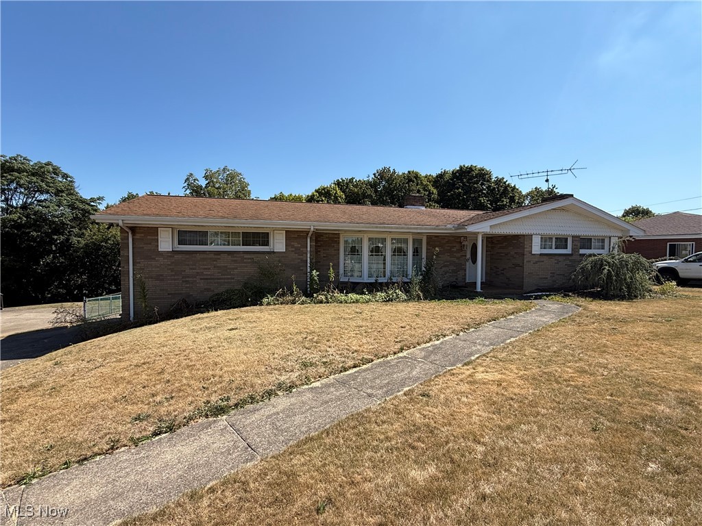 Sprawling brick ranch directly across from Steubenville Country Club. This home welcomes you into a large foyer that expands into a formal living room with bay window that flows directly into a formal dining room that opens to the entertainers kitchen with breakfast area. From the breakfast area, you will find a covered patio overlooking the large fenced in backyard. Back in the house you will find a powder room off the kitchen and a large den with fireplace. The first floor also encompasses, two large bedrooms and a full bathroom. The lower level features a third bedroom and another full bathroom, a utility room and a large three car garage. The Large driveway offer plenty of room for turning around as well