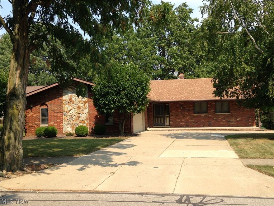 This spacious ranch with a full walk-out basement is loaded with numerous extraordinary features and it backs up to the Stearns Homestead!  Large great room with a vaulted ceiling,  large skylight,  wet bar,  sliding door to a wood balcony/deck and a beautiful fireplace with stone hearth and towering stone fascia  *  Huge walk-out basement that has a full bath,  wet bar,  fireplace with brick fascia and a wood mantle and sliding door to a long patio  *  Spacious Eat-in kitchen with numerous cabinets  *  Two staircases to the basement with one from the garage  *  A very large garage (28 x 23) with 2 floor drains,  hot & cold water,  two grade doors and pull down stairs to a floored attic space  *  Large elevated deck/balcony (31 x 6) off the great room and master bedroom  *  Large laundry room with utility sink, 2 closets and cabinetry located conveniently between the kitchen and garage  *  Master Bedroom with vaulted ceiling, cedar lined walk-in closet,  sliding door to the wood balcon