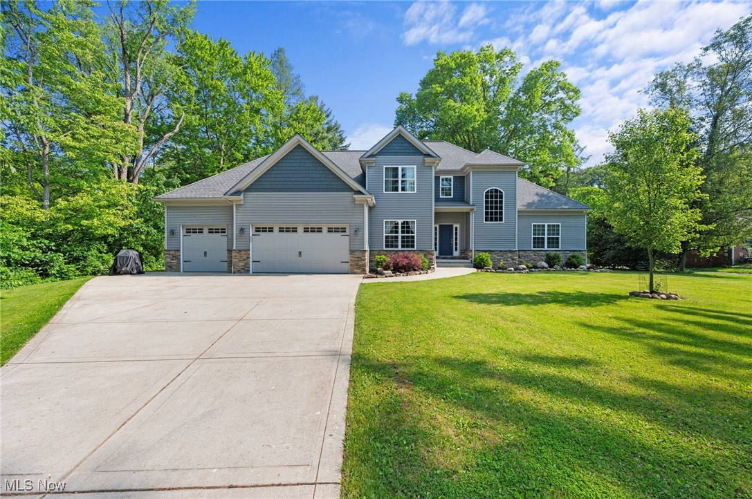 Welcome to this stunning custom home nestled on a picturesque one-acre lot in the desirable Brecksville City School District. Offering true multi-generational living, this home features a private in-law suite and showcases exceptional craftsmanship throughout. Beautiful curb appeal welcomes you into a thoughtfully designed interior with 9 ft ceilings throughout- including the basement—and 8 ft sliding doors to both patios. The spacious living area offers an open floor plan, large windows that fill the space with natural light, and a gas fireplace with a stone surround as the focal point. The chef’s kitchen features American Woodmark cabinetry, granite countertops, backsplash, stainless steel appliances, two pantries, and a large center island—perfect for gathering. The adjacent dining area opens to the patio, and the formal dining room is ideal for hosting special occasions. Enjoy first-floor living with a generous owner’s suite that includes a walk-in closet and a luxurious private bath. A half bath and laundry room complete the main living area. The private in-law suite is a standout—ideal for elderly parents, adult children, or guests—complete with its own entrance, living room, full kitchen with granite counters and stainless steel appliances, spacious bedroom, walk-in closet, full bath, and laundry hookups. A sliding door opens to a second patio, and separate garage access adds even more value. Upstairs offers two additional bedrooms with large closets, a full bath with 6-ft tub, and two unfinished rooms that could be finished into extra bedrooms. The lower level features solid poured concrete walls with waterproofing and rough-ins for a bathroom, ready for your finishing touches. An attached three car heated garage. The backyard with a fire pit, a shed, and is surrounded by beautiful mature trees providing privacy. Great location minutes to Cleveland Metro Park & downtown Brecksville with local shops & restaurants. Experience this remarkable home for yourself.