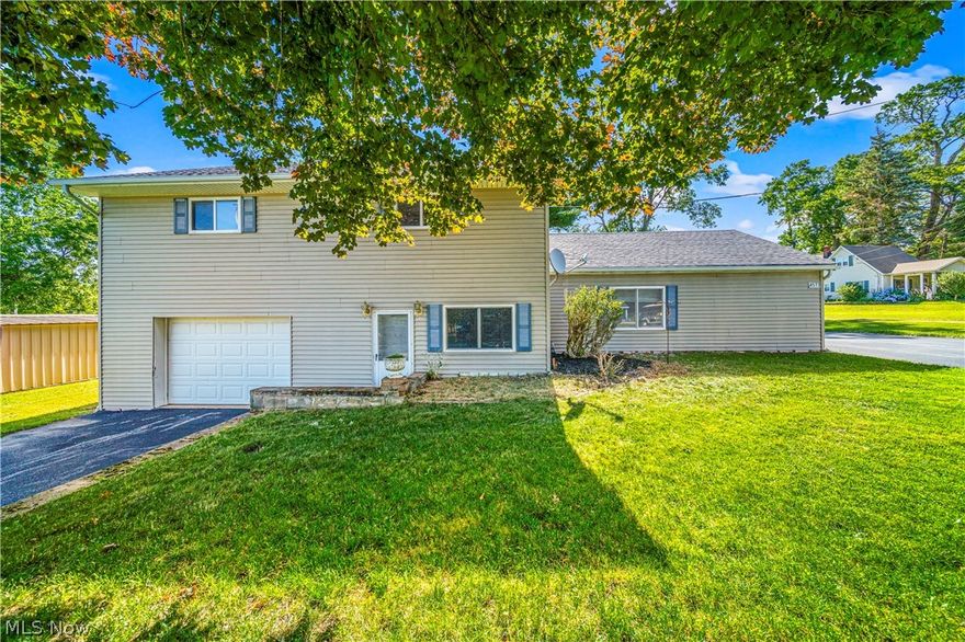 PRICE REDUCED!  This charming split level, located in a picturesque setting, is awaiting your decorating touches.  On the main floor, you'll find an open concept living room/dining room, one full bath, pantry, charming kitchen and sitting area round out the main floor.  Four large bedrooms and a full bath are on the upper level.  Large family room with outside entrance and a large laundry/utility room make up the lower level.  Enclosed, covered porch is perfect for morning coffee while enjoying the picturesque view.  Oversized garage, 1/2 acre of land.