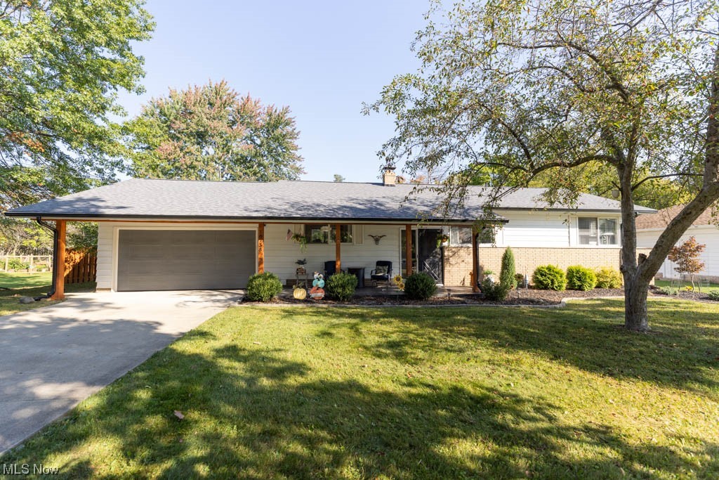 Welcome to 18738 Bonnie Lane, located in the heart of Strongsville! The moment you step out of your car, you will notice the beautiful curb appeal this ranch has to offer. From the wood wrapped and stamped concrete porch to the landscaping. Once inside the kitchen is completely updated with soft close, shaker cabinets, quartz counters, stainless steel appliances and tile backsplash. Off of the kitchen is an area for a dining table that leads to the sliding patio door. From there, the hardwood floors flow into the living room with a gorgeous stone fireplace surround that goes all the way to the ceiling. Down the hall you will find the first full bathroom with a double sink vanity along with the three bedrooms. All with hardwood floors and ample closet space. Head down to the finished basement with luxury vinyl flooring and a wide open space. This area is perfect for entertaining and where the second full bathroom is located. Off the side of the basement is the unfinished portion, which