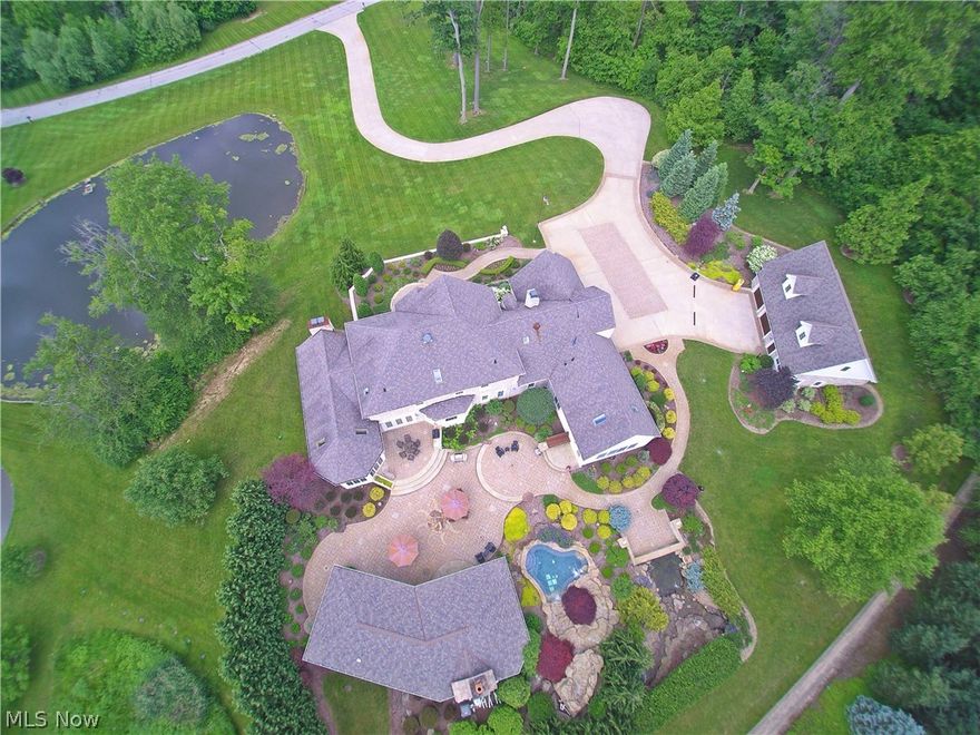 Spectacular country estate on 6.2 acres of privacy and fun. This home has EVERYTHING you have been looking for! Wonderful open floor plan with huge kitchen and breakfast room leading to stunning great room with custom beamed cathedral ceiling and 2-story stone fireplace. Impressive 275 gallon fish tank adds drama between dining room and great room. Gorgeous turreted family room with pine ceiling and stone floor leads out to stunning backyard oasis. Beautiful first floor master suite with walk out to back patio. Second floor offers four spacious bedrooms and 3 newly renovated baths. Backyard is a true oasis with waterfalls, rock surround hot tub, and incredible entertainment cabana with full kitchen and wood burning fireplace. Amazing spaces inside and out to entertain family and friends or just curl up with a good book and a glass of wine. Professional landscaping, 2 stocked ponds and exceptional stonework add much to the value of this exceptional property. 3 car attached garage, PLUS