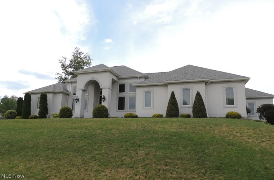 Quality custom built contemporary ranch. Original owner/builder designed for himself with care and high end finishes.  One floor living at it's  best. Huge granite counters and eating bar in kitchen. Bamboo flooring in living room and master suite. Cork flooring in office/den. Newly installed 800 sq. ft stamped patio for outdoor entertaining. All bedrooms prewired for multi-media hookups. Wired smoke detectors in all rooms. Three car attached garage with room for storage or toys. High ceilings in lower level ready to finish with rough in for another bath. Great open concept floor plan. Not your typical home for area, a must see.