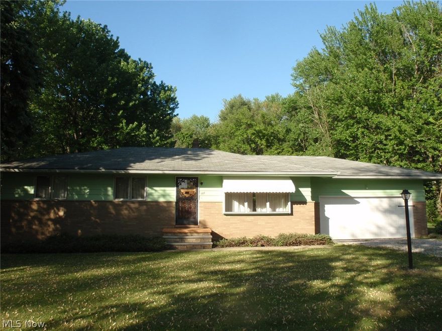 Nice and clean ranch with 2 car attached garage.  Beautiful hardwood flooring in living room, dining room, hallway and all 3 bedrooms.  Retro kitchen with wood cupboards and cabinets, pantry, built in range and over and dining area.  Formal dining room has patio door to rear deck.  Basement has rec room with pool table that will remain with the home. Parklike backyard with plenty of room for gardens or swing sets.   The home is located in Erie County and the adjoining lots are in Lorain County.  This is an additional paarcel 01-20-027-108-002.  The homestead reduction has been added back into the tax figure and it also includes the additional parcels.