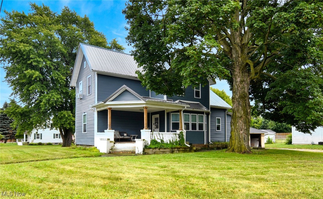 Welcome to this beautifully updated historic home set on a picturesque corner lot in Amherst. Thoughtfully modernized with a new metal roof, updated vinyl siding, and windows, the property blends timeless charm with modern comfort. A wide driveway leads to a two-car detached garage with a newer roof, and the grounds feature classic flagstone accents, a decorative well pump, and a welcoming front porch with a brick and fieldstone foundation. Inside, the home opens through a spacious side entry landing into a vaulted laundry/mudroom with tile flooring—bright, airy, and practical, with washer and dryer included. The kitchen is a true showpiece, boasting abundant light, a generous dining area, butcher block island, stainless steel appliances, and ample cabinetry that balances clean rustic yet modern style. The living room impresses with soaring ceilings, a distinctive octagonal bump-out framed by five windows, and an elegant banister. The first-floor master suite offers a private retreat with a spa-like bath featuring a soaking tub, walk-in shower, water closet, and large tile floors. Upstairs, you’ll find three additional spacious bedrooms and a large full bath with double vanities and walk-in closet. Rounded hallway details and vaulted ceilings add architectural character throughout. With four bedrooms, two full baths, updated systems, and a layout designed for both daily living and chic entertaining, this home combines historic character with fresh, move-in ready appeal. Please enjoy our attached video tour and request your private viewing.