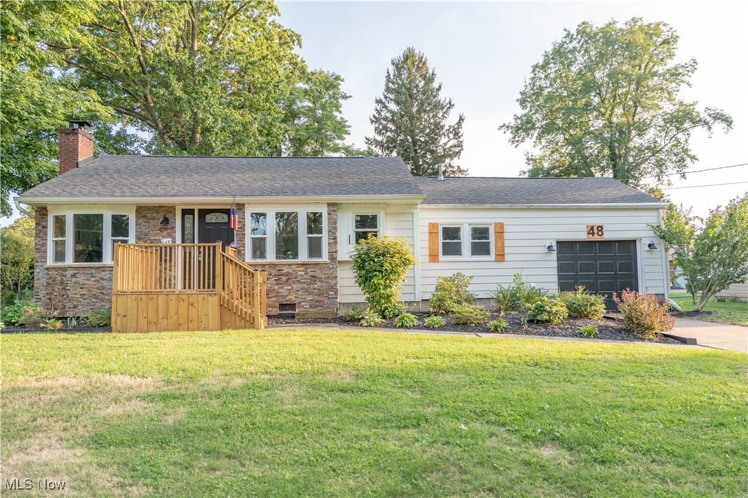 Welcome to this beautifully remodeled 2-bedroom, 1-bath ranch in Painesville Township, located in the desirable Riverside School District. This move-in ready home features an eat-in kitchen with pantry, tile flooring, concrete countertops, tile backsplash, additional butcher block counter space, and all appliances included. The living room offers a wood accent wall, wood-burning fireplace, and new luxury vinyl tile flooring. Both bedrooms have brand-new carpeting. The full bathroom has been fully updated with a tile surround, luxury vinyl tile flooring, concrete countertops, and all new fixtures. The laundry room includes a washer and dryer, new tile flooring, and updated utility sinks. Enjoy outdoor living on the covered wood deck overlooking a spacious, fully fenced-in backyard. Additional updates include a newer A/C and furnace, new electrical panel (2025), all new fixtures, brand new insulated garage door with Genie garage door opener (2025), fresh interior and exterior paint, updated landscaping, new wooden front deck and a striking new stone exterior. A fantastic opportunity for a turnkey home in a convenient location!