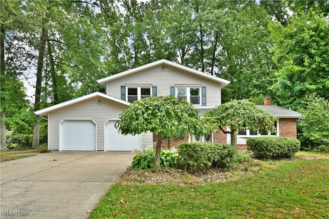 Your wait is over, the one you’ve been waiting on is hitting the market with a sprawling four-bedroom, move-in-ready layout! The stunning Howland residence awaits your attention as its tucked away within a highly desirable neighborhood, wrapped in a tree lined lot. Handsome brick work accents the covered front porch as a two car attached garage graces the cement driveway. A fenced-in backyard brings park-like views, a huge rear patio and a bonus storage shed. Step through the dual entry doors to find a mirror and tile lined foyer. The raised living room takes full advantage of its four-pane bay window as stone wrapped stairs lead to the second-floor bedrooms. Around the corner, formal dining brings decorative lighting and soft carpets. The central kitchen boasts floor to ceiling cabinetry and stainless-steel appliances. Dropping down, the dining area enjoys immediate patio access. Meanwhile, a colorful first floor guest bedroom sits across from a like-styled half bath. Completing the floor, a must-see rear family room showcases its hall-like presence, wowing with its pent roof and window lined rear section. Multiple skylights add to the allure. The stone shod fireplace seals the deal. Upstairs, the four engaging bedrooms line the main hall to include the larger master suite and its full private bath. A second full bath sits mid hall with its relaxing soaking tub. Down below, a partially finished basement allows for easy storage and utility access.