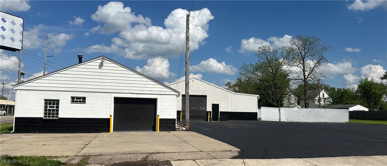 Incredible opportunity 2 buildings and 4 parcels. 3 zoned light industrial and one residential. Each building has 2 drive in doors and measures about 1200 sq.ft. & 1920 Sq ft. Included in the buildings is an industrial car lift. Buildings have been updated. To name a few: Freshly painted, electric, new overhead lights, new water tank new parking lot lights. A few exterior and interior doors. New fiberglass roof and gutters and insulated on small building. The larger building roof has been recoated, new block windows. Bathrooms have been updated. New concrete in a section of large build. New steel on ceiling and new supports in little building. Steel wall in large building. This very versatile property allows the owner to use the entire property or use one for cash flow. There is a residential lot you can build a home or rental property on .13-acre vacant lot zoned R-TH allowing up to a two-family home to be built. Each parcel has it own parcel number. This unique piece of property has plenty of parking. Recently parking lot has patched and sealed. Owner is an Ohio licensed Real Estate Agent.