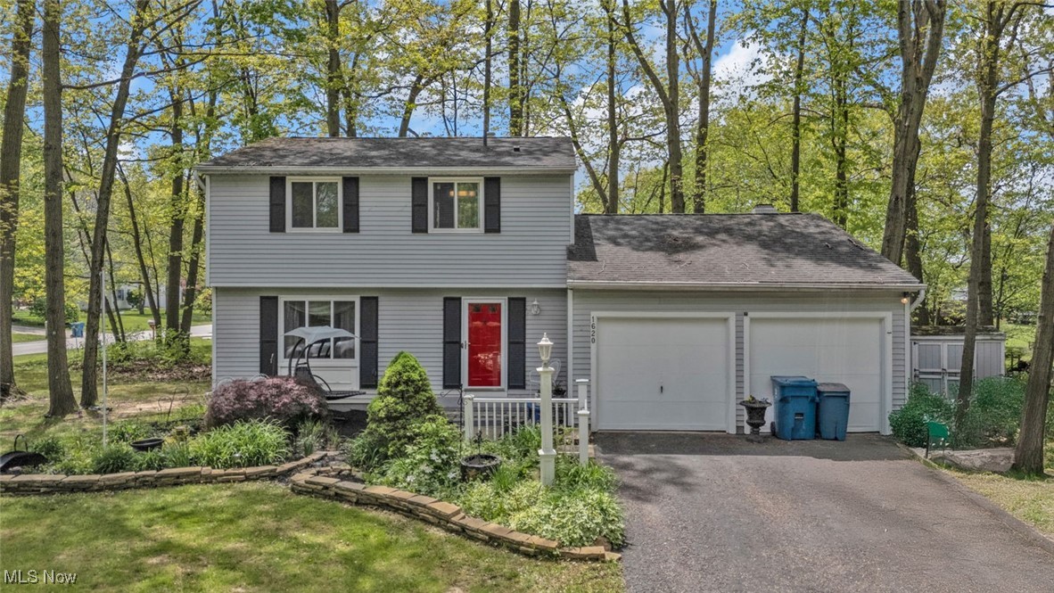 Nestled on nearly half an acre in the highly rated Hudson City School District, this 3-bedroom, 1.5-bath colonial offers 1,488 square feet of warm, move-in-ready space. Inside, you'll love the seamless blend of comfort and style. The eat-in kitchen features stone countertops and durable laminate flooring (2011), flowing into a spacious family room with a cozy fireplace and sliding Anderson patio doors (2005) that lead to your private backyard retreat. A formal dining room and large living room provide flexible space for everyday living or entertaining. Upstairs, three generously sized bedrooms are complemented by an updated full bath (2018). The first-floor half bath was remodeled in 2012, and plush carpet was replaced throughout the home in 2018. Fresh interior paint and trim (2018) add a modern, neutral touch. Other updates include a water softener (2011) and newer windows throughout. Enjoy the beauty of the outdoors with the home exterior and shed professionally painted in 2010, all set beneath a peaceful canopy of mature trees. The partially finished basement offers a dedicated office space and plenty of room for storage or hobbies. Home warranty included!