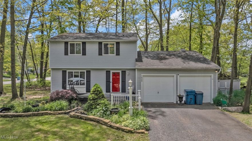 Nestled on nearly half an acre in the highly rated Hudson City School District, this 3-bedroom, 1.5-bath colonial offers 1,488 square feet of warm, move-in-ready space. Inside, you'll love the seamless blend of comfort and style. The eat-in kitchen features stone countertops and durable laminate flooring (2011), flowing into a spacious family room with a cozy fireplace and sliding Anderson patio doors (2005) that lead to your private backyard retreat. A formal dining room and large living room provide flexible space for everyday living or entertaining. Upstairs, three generously sized bedrooms are complemented by an updated full bath (2018). The first-floor half bath was remodeled in 2012, and plush carpet was replaced throughout the home in 2018. Fresh interior paint and trim (2018) add a modern, neutral touch. Other updates include a water softener (2011) and newer windows throughout. Enjoy the beauty of the outdoors with the home exterior and shed professionally painted in 2010, all set beneath a peaceful canopy of mature trees. The partially finished basement offers a dedicated office space and plenty of room for storage or hobbies. Home warranty included!