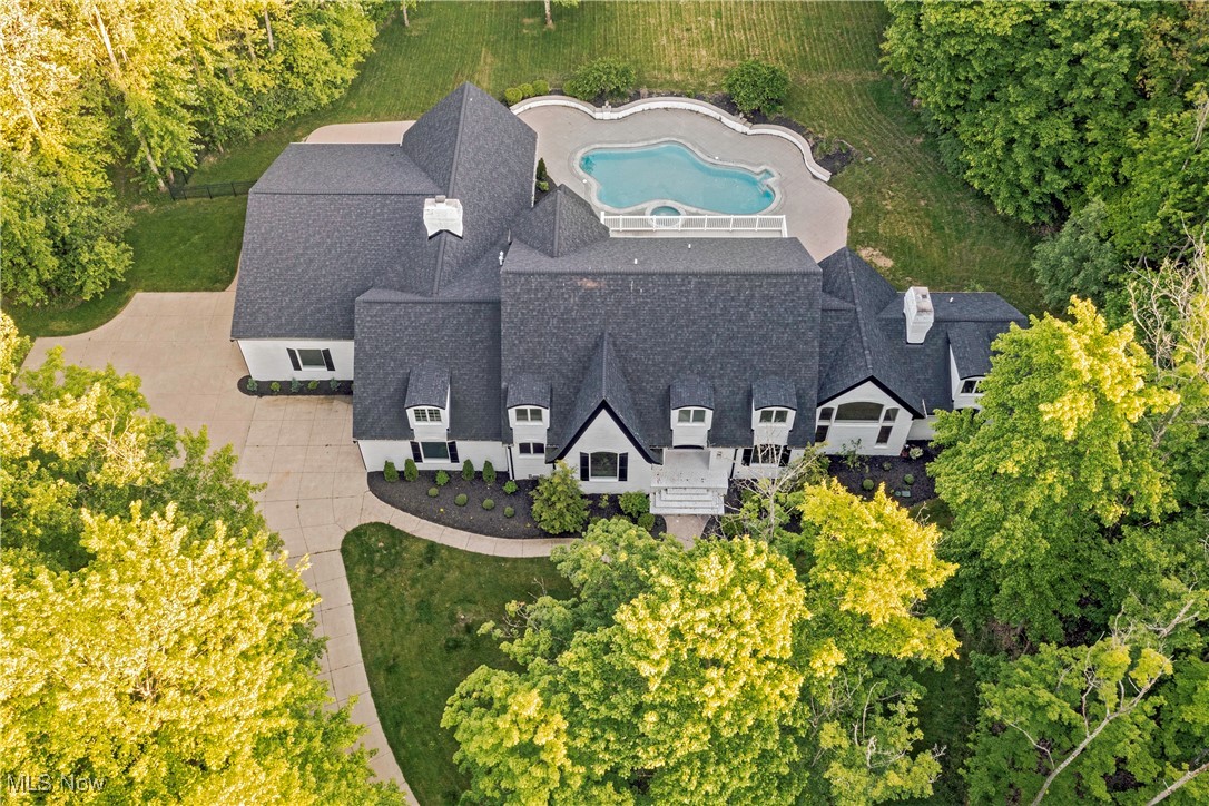 : Exceptional craftsmanship meets modern elegance in this stunning, completely redesigned home in Bath. This
spectacular property features soaring ceilings, oversized windows, and a stunning backyard oasis complete with a
gorgeous pool, spa, oversized patio and a screen enclosed stone porch. 7” French white oak flooring flows throughout the
main living areas. Prepare to be blown away by the open gourmet chef’s kitchen boasting two massive islands, quartz
countertops, custom cabinetry, and Thermador appliances including dual dishwashers. All opened to a dramatic sitting
area with limestone fireplace. From the kitchen step outside to the backyard oasis, or retire to the adjacent lounge for an
after-hours aperitif. Other living areas on the first floor include a formal sitting room, an office, and an open flex room
with french doors that open out for easy al-fresco dining. The first floor primary suite is a luxurious retreat, complete with
a limestone fireplace, soaring ceilings, and a stunning en-suite with blue travertine floors, a solid granite soaking tub, and
a generous walk-in closet. Upstairs, there are four bedrooms and two bathrooms, including a second primary suite with a
large terrace that overlooks the yard and pool. Outside, a charming screened-in porch opens to the pristine pool and patio,
all surrounded by old-growth trees for peace and privacy. Situated on 4.76 acres at the end of a cul-de-sac street, this
home is a true masterpiece of comfort and style.