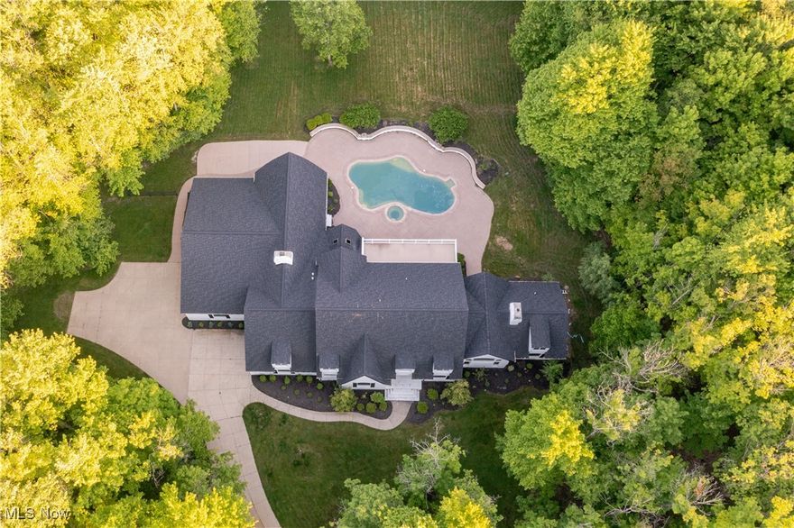 : Exceptional craftsmanship meets modern elegance in this stunning, completely redesigned home in Bath. This
spectacular property features soaring ceilings, oversized windows, and a stunning backyard oasis complete with a
gorgeous pool, spa, oversized patio and a screen enclosed stone porch. 7” French white oak flooring flows throughout the
main living areas. Prepare to be blown away by the open gourmet chef’s kitchen boasting two massive islands, quartz
countertops, custom cabinetry, and Thermador appliances including dual dishwashers. All opened to a dramatic sitting
area with limestone fireplace. From the kitchen step outside to the backyard oasis, or retire to the adjacent lounge for an
after-hours aperitif. Other living areas on the first floor include a formal sitting room, an office, and an open flex room
with french doors that open out for easy al-fresco dining. The first floor primary suite is a luxurious retreat, complete with
a limestone fireplace, soaring ceilings, and a stunning en-suite with blue travertine floors, a solid granite soaking tub, and
a generous walk-in closet. Upstairs, there are four bedrooms and two bathrooms, including a second primary suite with a
large terrace that overlooks the yard and pool. Outside, a charming screened-in porch opens to the pristine pool and patio,
all surrounded by old-growth trees for peace and privacy. Situated on 4.76 acres at the end of a cul-de-sac street, this
home is a true masterpiece of comfort and style.