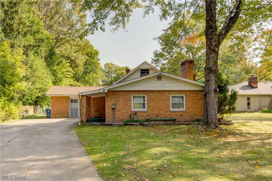 Welcome to 828 N Munroe Rd - This 3 bedroom Brick Cape Cod sits on 1.25 ACRES! The first floor features a Spacious Living Room with stone wall and wood burning fireplace that is Open to the Updated bright Kitchen with newer countertops, flooring, cabinets and backsplash. Two additional bedrooms, one with 1/2 bath and Full bathroom finish off the first floor. The second level has a Large bedroom with extra storage. The one car attached heated garage was used as "man cave" but can easily be converted back to garage. Park like backyard is completely fenced with a basketball court and outbuilding/1 car garage. Don't miss your opportunity to enjoy land in Tallmadge. Call for your appointment today!