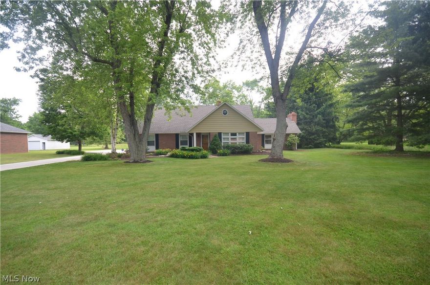 Tallmadge 1 owner home w 6 possible bedrooms, Incredible curb appeal & located on a massive 1.7 acre lot w fantastic privacy & large shed! Concrete driveway with turn around area leads to the big 2 car detached garage w electric and opener. Paver patio out back overlooks the gorgeous back yard. Front door leads to a foyer entry to a large living rm – big enough to include a formal dining area, if desired. The updated kitchen includes raised panel cabinets, beautiful counters, tile backsplash, 2 pantries and an eating area- with easy access to the giant family room w brick woodburning fireplace surrounded by bookshelves and cabinets. Off of the family room find a spacious 3 season sunroom w ceiling fan overlooking the back yard- a fabulous place to sit and relax! The 1st floor includes a spacious laundry room, 3 bedrooms (or space for a home office/hobby room), a nicely updated full bath w tile floor & step in shower & lg vanity. 1st floor master bedroom potential with 1 bedroom offerin
