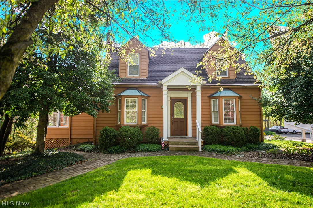 Own this charming four bedroom, four full bathroom home on the edge of town! First floor master suite with giant 22' long walk-in closet. Labeled the "Charm House" by Cambridge Lumbar in 1941, this beautiful home features a home addition of 16' x 39' in 1996, and separate 20' x 24' garage built in 2002. Above the detached garage is a finished loft with full bath and kitchenette - perfect for a man cave, children's club house, or extra rental income! The best part - the garage and loft are heated and cooled! Extra garage with room for two vehicles under the main house. Gas forced air and central air by heat pump in the main home. Enjoy a book by the wood burning or gas fireplace or on the private 10' x 14' rear deck, with views of wooded scenery. Rear patio and deck are very private and quiet. Radon gas system, full home security system, 200 amp electric service, triple pane windows, reverse osmosis filter on kitchen sink, whole house Pelican filter and water softener. Fully insulated w