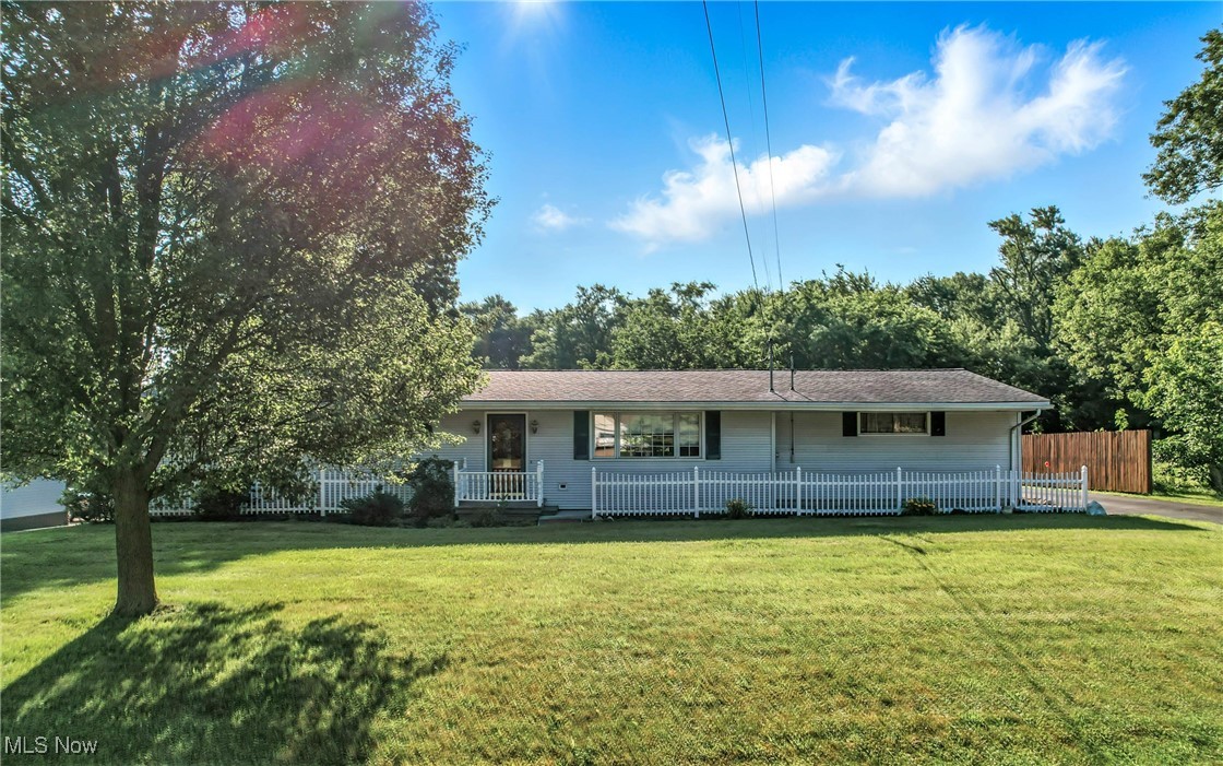 Welcome to 1808 Depot Road in Salem, Ohio—an immaculately maintained, one-owner ranch home that radiates warmth, charm, and pride of ownership. Framed by a classic white picket fence, this rare 4-bedroom, 2-bath home features gorgeous hardwood floors throughout and a bright, spacious living room perfect for gathering. The lovely eat-in kitchen offers direct access through sliding glass doors to a peaceful backyard patio—ideal for relaxing or entertaining. The expansive lower level is a standout, showcasing a large family room with built-in booth seating, a generous laundry room, and ample storage space. Additional highlights include a 2-car attached garage, paved driveway with extra parking, and a large backyard complete with a shed/additional garage for all your tools and toys. This home offers a rare combination of space, function, and beauty—don’t miss your chance to make it yours!