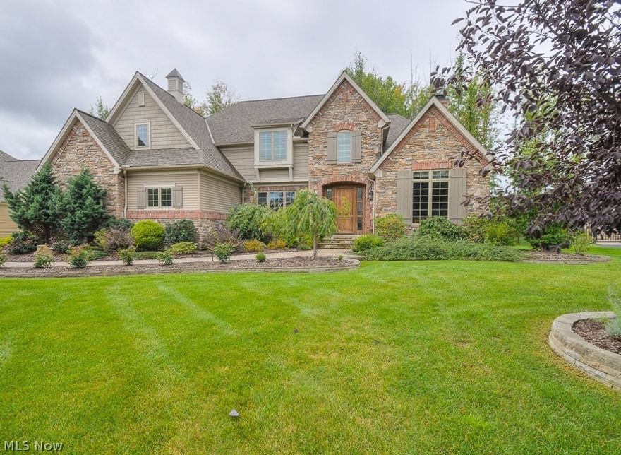 Rare opportunity to own an immaculate custom-built & beautifully decorated executive "Homearama" home, on an exclusive cul-de-sac, all tucked within a truly welcoming neighborhood. A grand foyer w/elegant chandeliers welcomes you into an entertainer's dream floor plan which flows invitingly between chef's Kitchen & Hearth room, and on to the soaring 2 story Great room w/it's stunning stone beam fireplace. Enjoy wonderful sunset evenings either in front of the dual-fuel brick chimney fireplace w/it's own outdoor kitchen, or step back into the 3 season porch to relax with family & friends long into the night. This prestigious home boasts exceptional Amish craftsmanship throughout: including a richly appointed executive office & library, hand-hewn details throughout the entertaining spaces & extends sown to the beautiful full bar & wine cellar in the finished lower entertaining level. Spectacular gourmet chef's kitchen w/extra large custom granite island workspace, 2Wolf wall ovens & Wolf