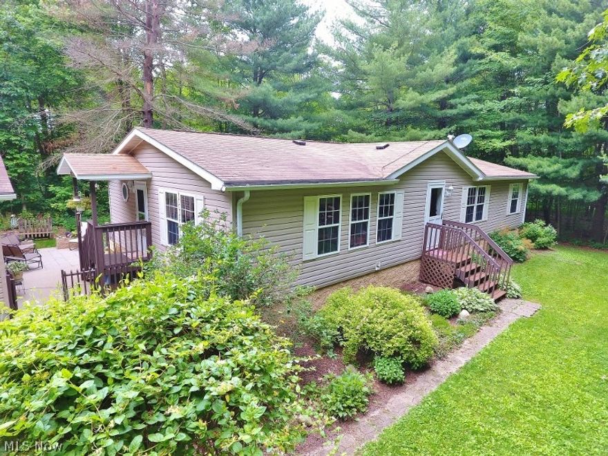 Privacy, tranquility & nature are great words to describe this ranch home situated on a beautiful wooded 1.74 acre lot at Atwood Lake in the Sunset Valley community. This lake home offer 3 spacious bedrooms & 2 baths. Docking rights are available through the Sunset Valley docking association and a community beach is available for your families enjoyment. The spacious living room provides plenty of space for your family and the culinary enthusiast will love the large eat in kitchen with a large center island. Vaulted ceilings throughout. The spacious master bedroom features a walk in closet, and large private updated bath with a garden tub and separate shower. 2 additional bedrooms both provide walk in closets. The second bath has also been updated. Additional updates include mostly new flooring, new skylights in bathrooms, and new hot water heater. The home has been very well cared for and ready for the new owners to just move in and enjoy. A oversized 2 car detached garage provides sp