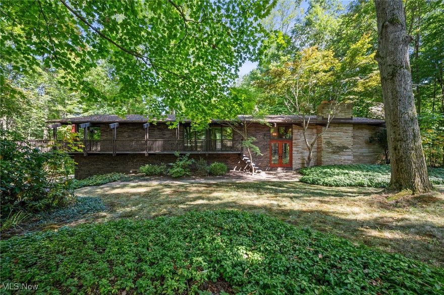 This extraordinary home has some of the finest timeless architectural details. Stunning views of the 1.96 acre wooded lot. From the beautiful stone wrapping the exterior of the home into the Great Room to the multiple decks and patios, this home is spectacular! Enjoy the change of seasons surrounded by trees and lush landscapes. Inside the home features 5 bedrooms, sliding doors in each of the bedrooms leading to the decks, and incredible wood ceilings and feature walls. This gracious home is ready for new ownership. A true opportunity to make this home your own. Come fall in love with 1345 Ledgewood Drive in Bath!