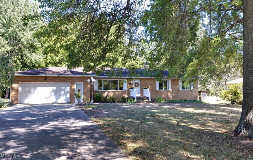 LOCATION, LOCATION, LOCATION!! *NOTE: Installation of city water and sewer are currently being scheduled as of 10/01/2025!! Check out this all-brick ranch home near the heart of Norton, just a few houses down from the fire station, Columbia Woods Park and .3 miles from the Norton Shopping Plaza! This lovely home is nestled among mature trees in front and back, creating a beautiful canopy of color and shade! Step inside to a spacious living room with an electric fireplace, hardwood floors and a huge picture window which floods the room with natural light! Down the hall, you'll find 3 bedrooms, with newly-revealed hardwood floors, which you can finish however you like. The primary bedroom has a private entrance into the main bath which has a shower/tub combo, double sinks and plenty of storage. The eat-in kitchen has ample room for a table and chairs and leads to the sun-room which has a gas fireplace and a wall of windows, from which you may enjoy every season in the beautiful backyard. The unfinished basement is quite large and has a full bath, laundry and mechanical rooms, all of which can be finished to your personal specs. There is also a separate entrance to the house through the garage and the basement allowing for future development of an in-law suite or private quarters for another family member. Behind the house, there is a 23' x 8' concrete patio, a HUGE backyard and mature landscaping around the entire home, PLUS an extra wide concrete drive that has a triple-space turn-around for your peace of mind! Built to last in 1967, this home needs some updating, but it has great bones and an even better location - Just 1.4 miles from I76 and close to top rated Norton Schools: Norton High (.9 mi) and Norton Primary (.3 mi). Call your favorite Realtor and check it out today!
