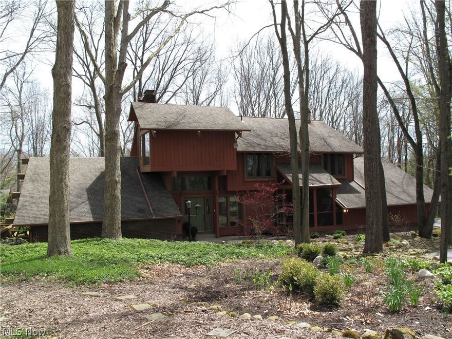 Nature lover's paradise situated on over 5 acres in Bath Township! This 5 Bedroom 3 Bath home offers a tranquil retreat for the intimate family life with all the conveniences to modern day living. The great room boasts a floor to ceiling stone fireplace, beamed ceilings and wrap around slider doors. The dining room leads seamlessly into the eat-in kitchen that offers ample cabinet space. 1st floor laundry/mud room opens into the 3 car garage. Master bedroom hosts a fireplace with updated master bath with heated floors. One of the home's notable features is the awe-inspiring backyard views and award winning gardens make this home a must see! HOME WARRANTY INCLUDED!