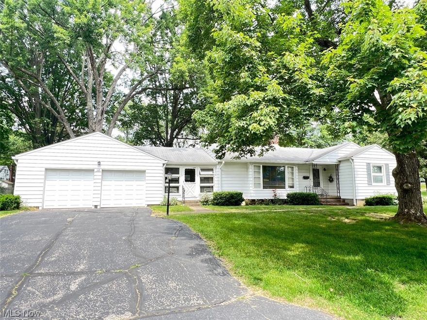 Great starter or downsize to one floor living. In same family for many years and very well maintained. Amish built cabinets in cozy efficient kitchen. Open floor-plan between living and dining areas. Dining has a wall of built-in cabinets. Mid-century details like the charming open fireplace. Oak flooring under all carpets. Lovely finished large breezeway between the house and garage with doors to rear, front, and to the large garage. Basement has been professionally waterproofed. Owner has done a pre-sale home inspection for review. See attachments.